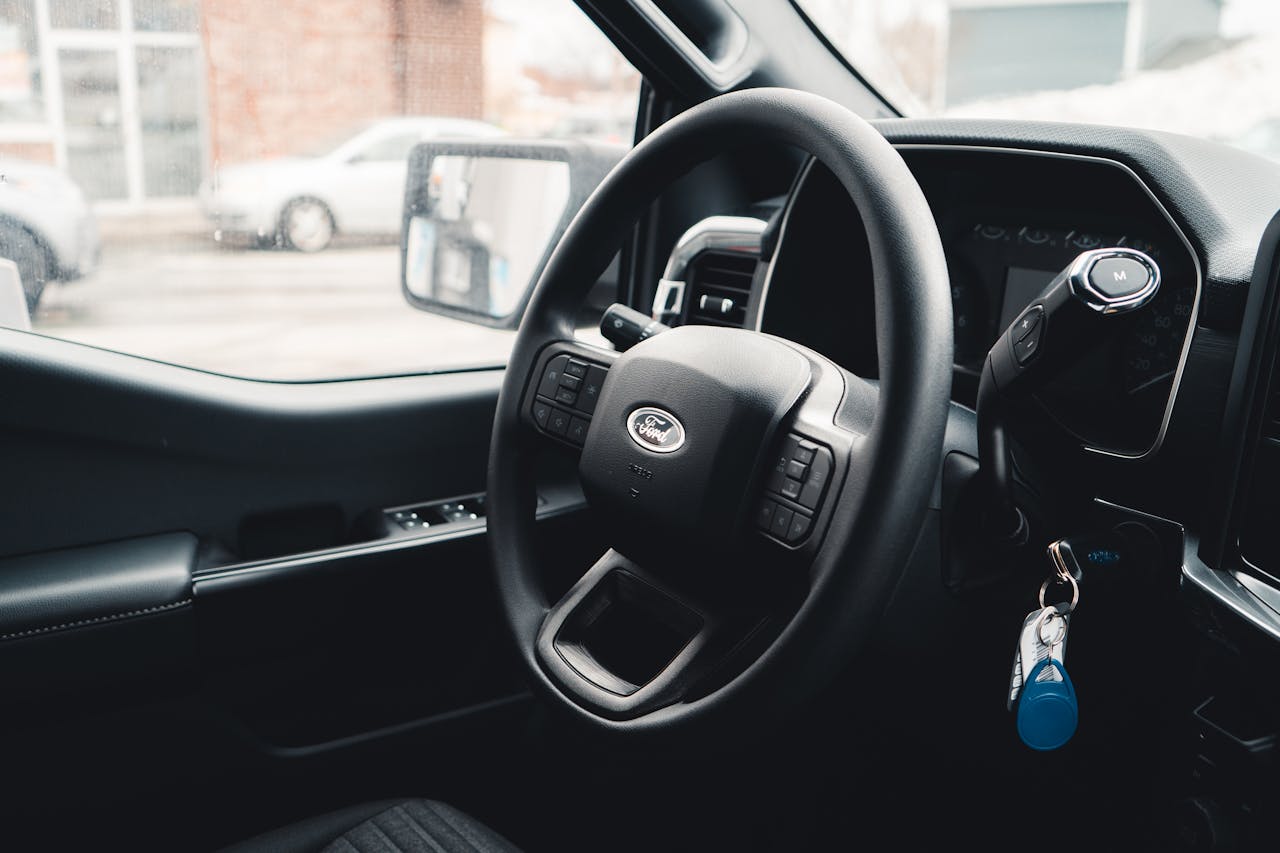 Crafting Captivating Headlines: Your awesome post title goes here Interior view of a Ford vehicle showing steering wheel, dashboard, and car keys for modern automotive design.